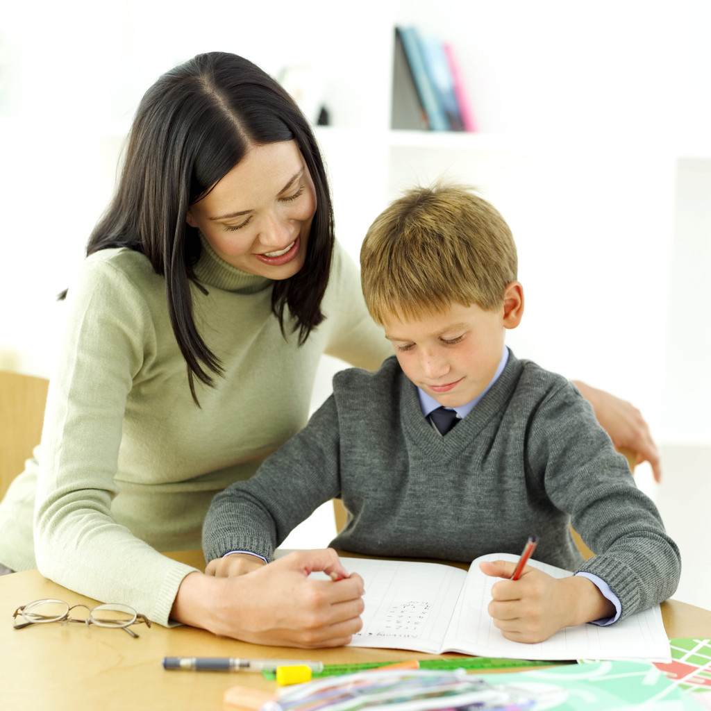 Young Boy Being Tutored by His Teacher --- Image by © Royalty-Free/Corbis