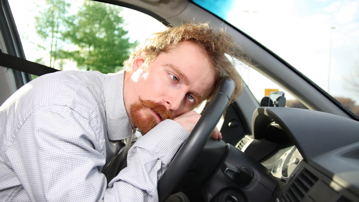 tired driver sleeps in a car