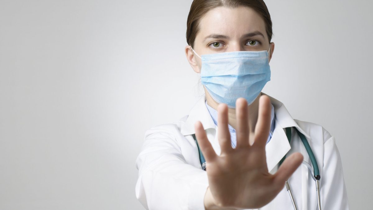 Doctor showing stop sign