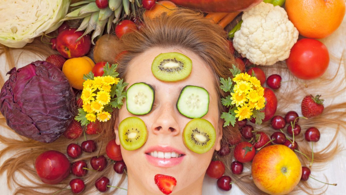 Female face with lot of fruit and vegetables