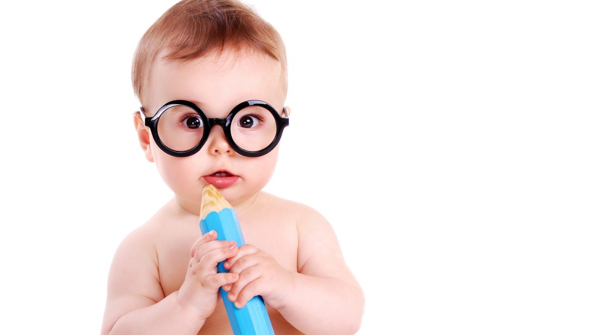 Baby boy wearing glasses and holding big pencil