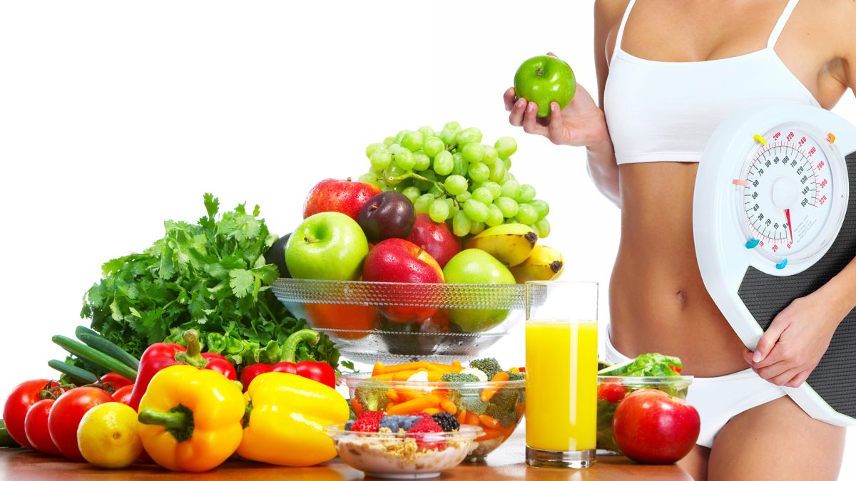 Young healthy woman with fruits and vegetables. Diet.