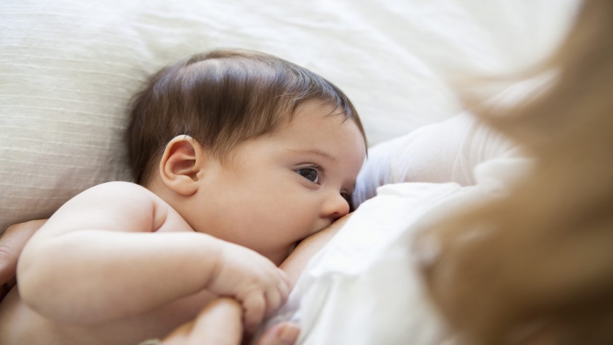 Mother breast-feeding baby girl