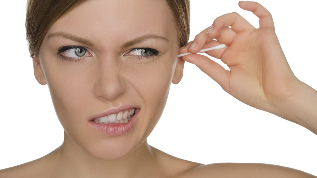 woman injured cleans ears with cotton sticks isolated on white